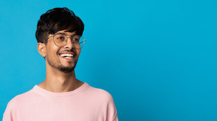 Closeup portrait of cheerful indian guy looking at copy space