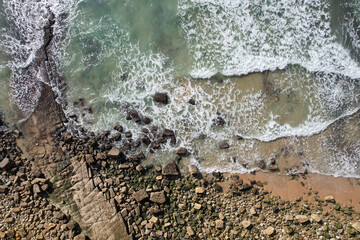 Beach and waves from top view. Turquoise water background. Summer seascape from air. Portugal Lagos Algarve. Travel concept and idea