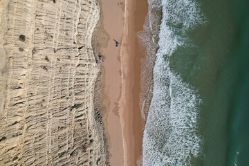 Fototapeta na wymiar Beach and waves from top view. Turquoise water background. Summer seascape from air. Portugal Lagos Algarve. Travel concept and idea