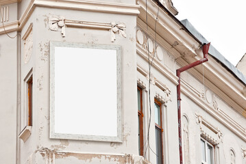 Rectangular sign on the building. Copy space and space for text. Mockup for design. Blank template for advertising. White frame on the facade of the house. Advertising on architecture.