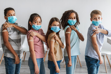 Diverse Group Of Vaccinated Children Showing Arms After Vaccination Indoor