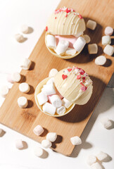 Cocoa bombs with marshmallows, chocolate that melts when hot milk is added for creating a trendy tasty drink. 