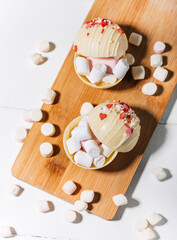 Cocoa bombs with marshmallows, chocolate that melts when hot milk is added for creating a trendy...