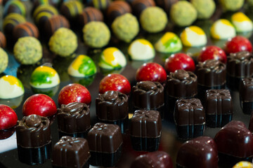 Colorful chocolate candies with different flavors. Exclusive delicious handmade sweets. 