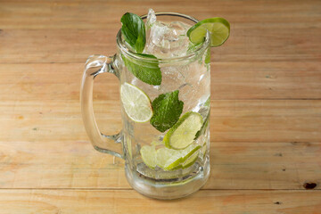 Mexican Drink - Mojito served in a jar on a wooden table and black background