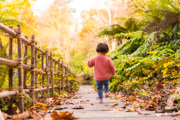 A girl running through a beautiful park in autumn