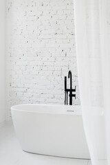 White bathroom with light tulle and classic bath