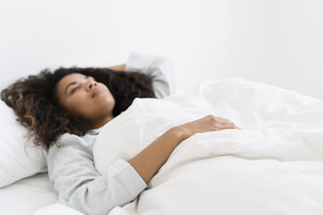 Obraz na płótnie Canvas Beautiful afro american woman sleeping in bed