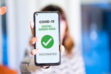 Green pass of the covid-19, a woman shows a mobile phone with the health passport. Vaccination...