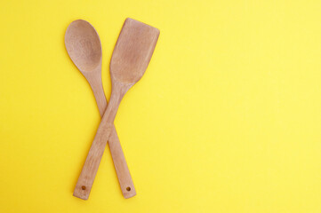 A set of bamboo dishes on a bright yellow background.