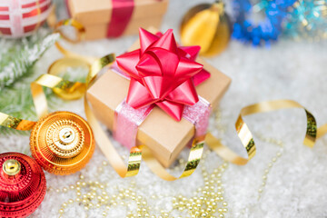 Christmas decor with decorations balls on a Christmas tree with serpentine and gift boxes with surprises