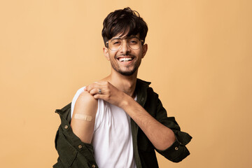 Healthy indian man with medical band on his shoulder