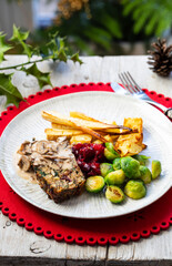 Vegetarian Christmas dinner with nut roast, mushroom sauce, roast parsnips and brussel sprouts