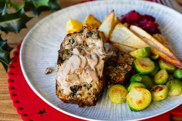 Vegetarian Christmas dinner with nut roast, mushroom sauce, roast parsnips and brussel sprouts