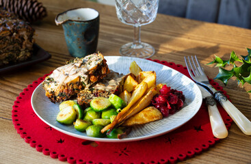 Vegetarian Christmas dinner with nut roast, mushroom sauce, roast parsnips and brussel sprouts