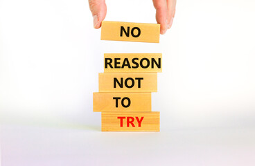 No reason not to try symbol. Wooden blocks with words No reason not to try. Beautiful white background, copy space. Businessman hand. Business, no reason not to try concept.