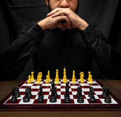latin man with beard challenging in chess game, chess concept