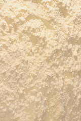 Background of white whey protein isolate powder. Heap of yellow protein powder isolated on white background. Top view.