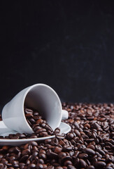 Cup of  aromatic coffee and roasted beans on wooden table. Space for text. Roasted coffee beans in a cup.