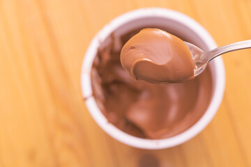 Selective focus shot of sweet cocoa cream in a teaspoon