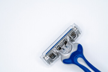 triple blade razor head in blue and gray colors on light background