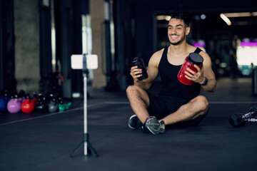 Fototapeta na wymiar Best Protein Powder. Arab Man Advertising Fitness Nutrition In Video Blog