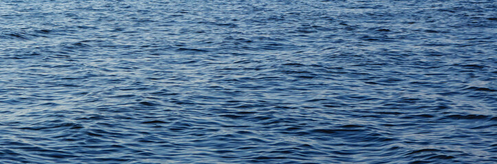 Blue water background, calm undulating ocean surface. Background for banner and design. Tourism and travel concept