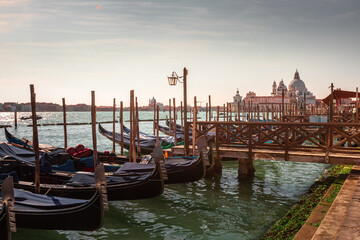 Fototapeta na wymiar Gondolas parked at Venezia with San Giorgio Maggiore church at the back, Veneto, Italy.