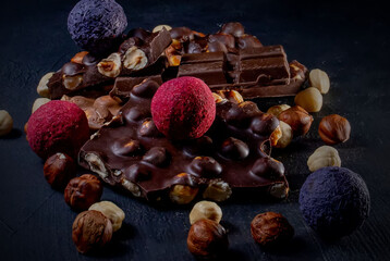 Chocolate bar, crushed pieces of dark chocolate and nuts. Praline Chocolate sweets