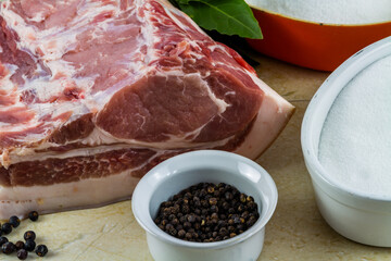 Pork loin of back joint with ingredients for dry curing into bacon.