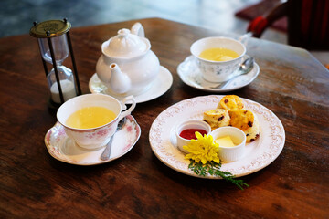 English tea set with desserts on wood table 1