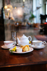 English tea set with desserts on wood table 2