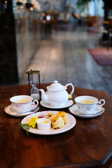 English tea set with desserts on wood table 3