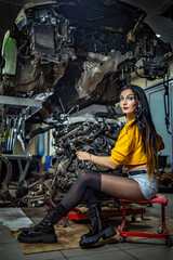 Fototapeta na wymiar Girl car mechanic in a car workshop