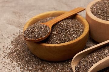 Bowl of organic natural chia seeds close-up on concrete background or table