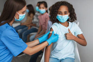 African Girl Gesturing Thumbs-Up Getting Vaccinated Against Coronavirus In Clinic