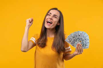 Studio shot of happy euphoric soccer fan girl celebrating her favourite team victory and money win...