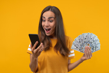 Portrait of surprised girl looking at her phone screen unable to believe she hit the jackpot in online lottery