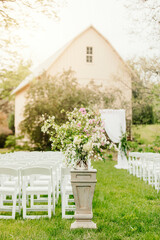 small outdoor barn wedding and wedding ceremony flowers and arch decorated for garden wedding 