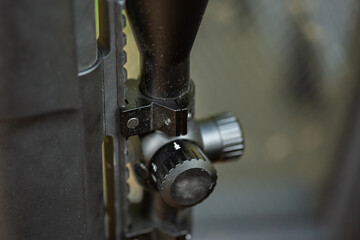 Close-up parts of automatic weapon with selective focus and blurred background