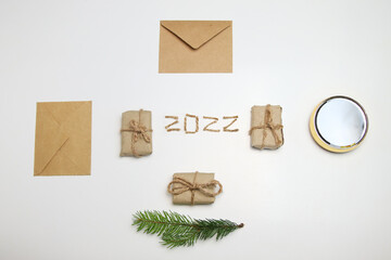 Brown eco gift boxes and craft envelopes. Number 2022. Happy New year 2022 welcoming New Year 2022...