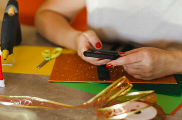 phone in hand against the background of decoration tools