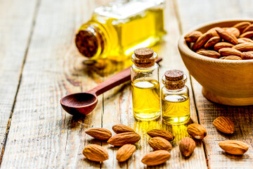 organic cosmetic with almond extract on table background