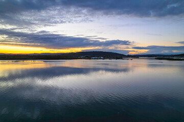 Sunrise aerial waterscape over the bay with cloud cover