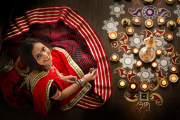 Woman arranging lights and rangoli 