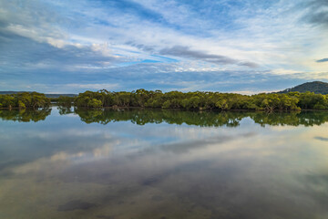 Clouds and reflections early morning waterscape