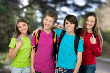 Happy secondary students in school. Young male and female carrying backpack outdoor
