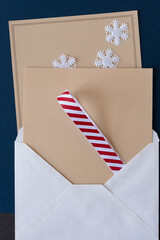 paper background with christmas elements (ribbon, snowflakes, envelope)