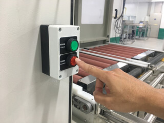 hand touch on button machine in factory industrial