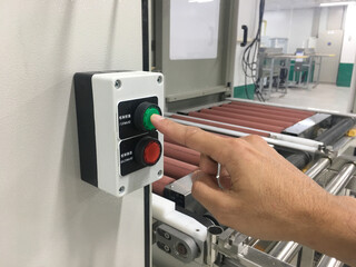 hand touch on button machine in factory industrial